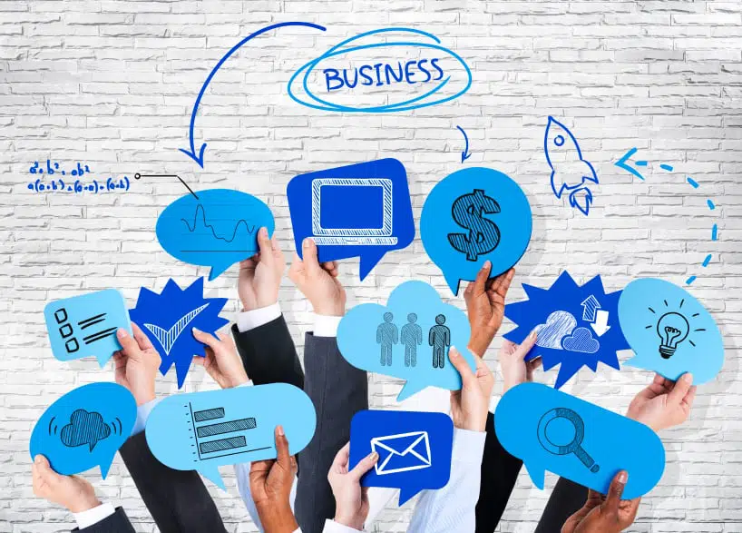 Business people's hands holding speech bubble with business theme