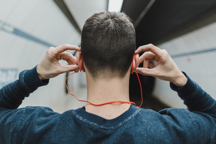 man-listening-to-earphones-in-subway