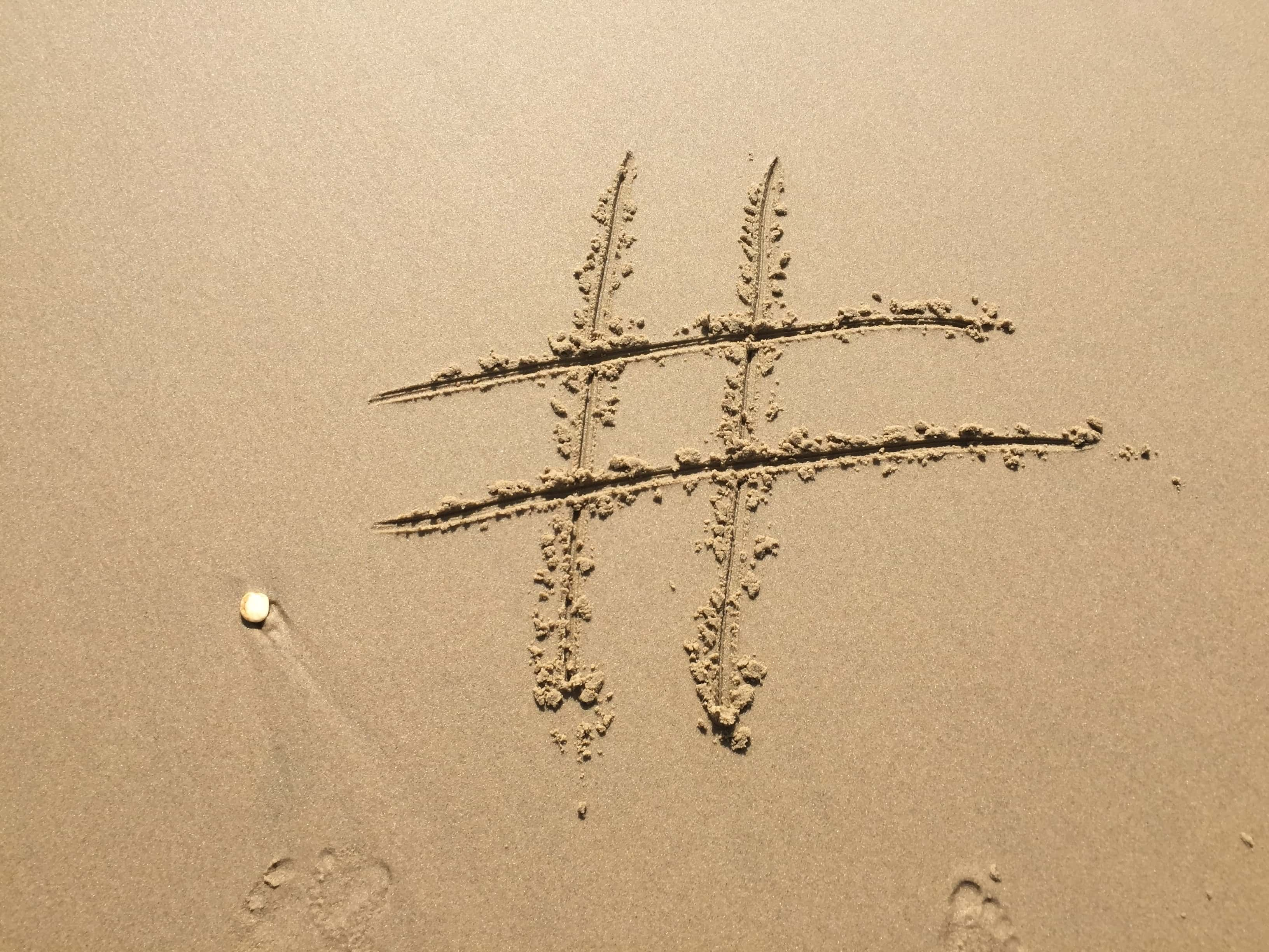 hashtag-written-in-sand