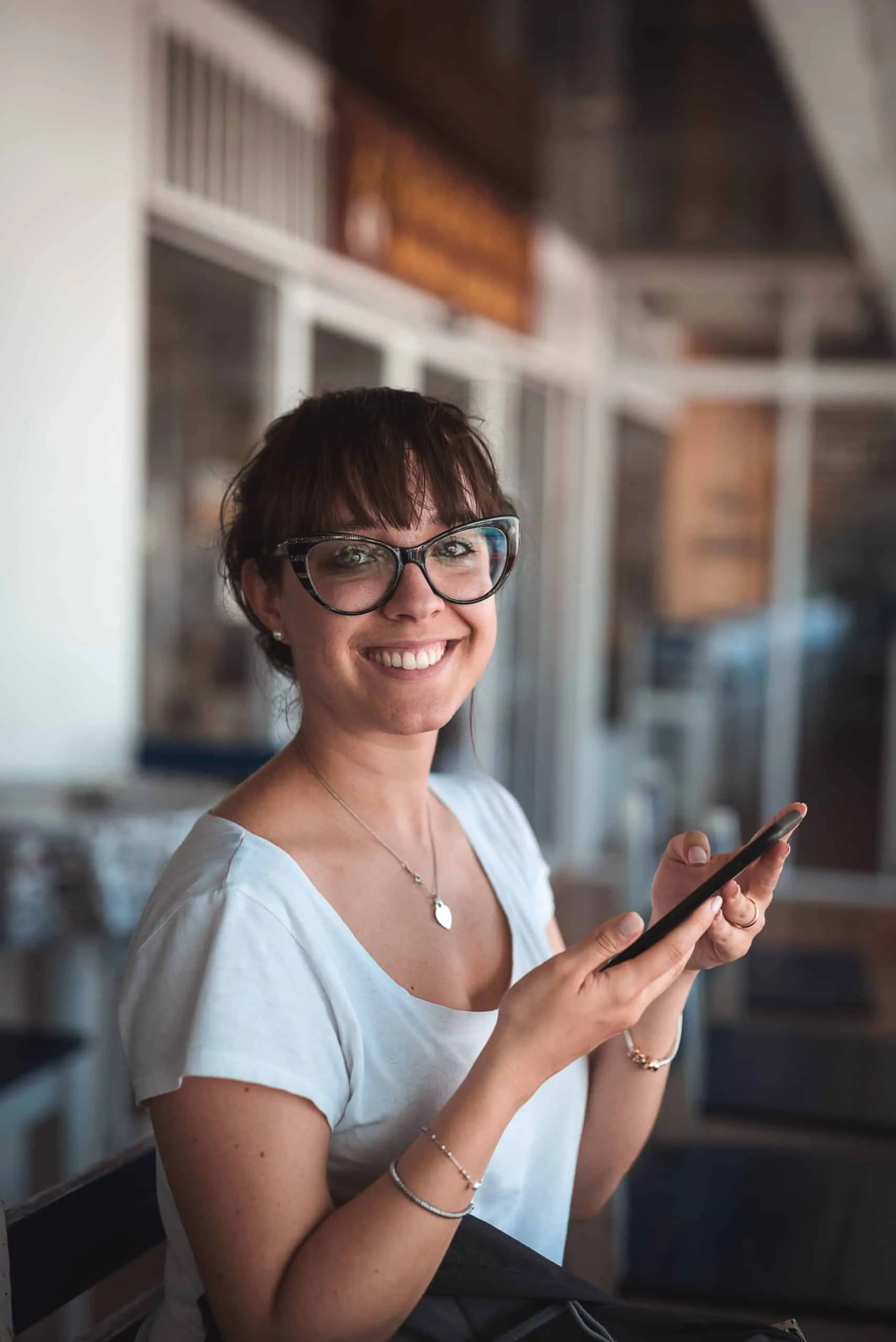 woman smiling using smartphone