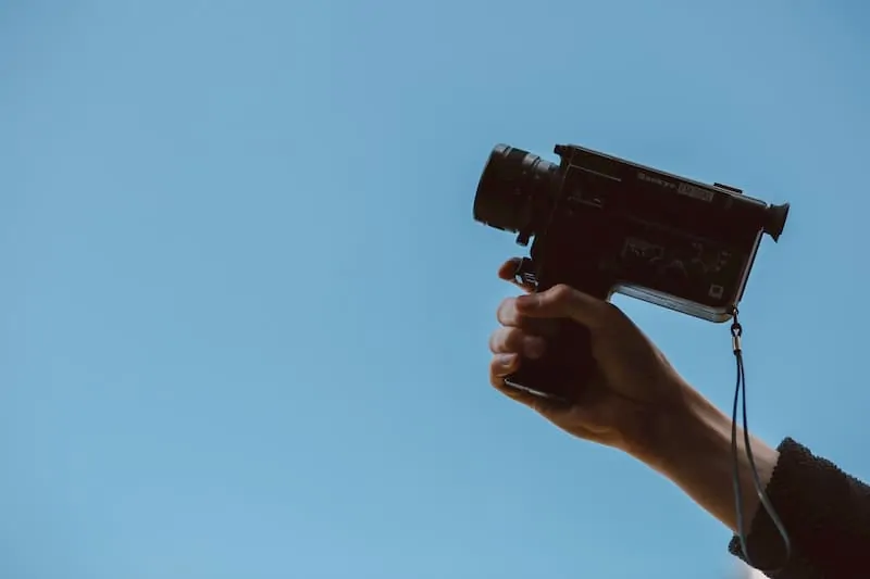 person holding camcorder