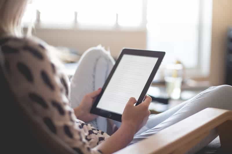 woman reading ebook on ipad